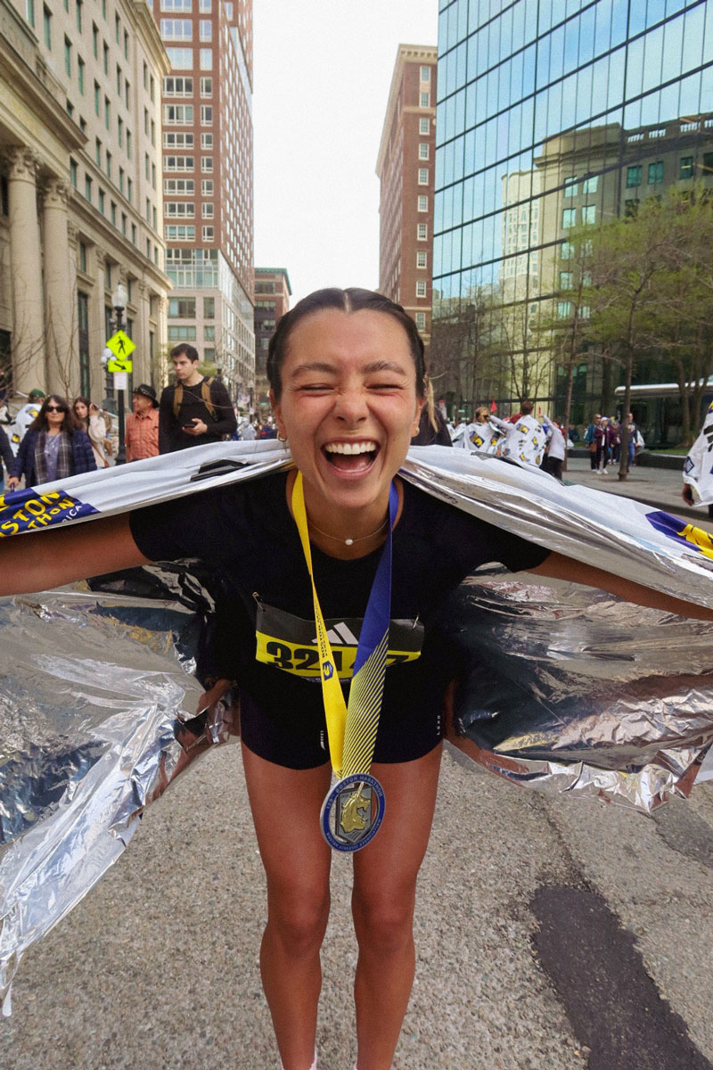 The coach is smiling after the marathon.